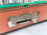 an old suitcase with a handle that has a picture of a horse on it