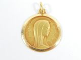 a close up of a gold coin with a woman ' s face on it