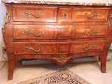 a marble top dresser in a room with a rug