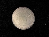 an image of a silver coin on a black background