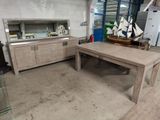a wooden table with a boat on it in a room