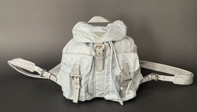 white leather backpack with straps on a black surface