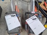 two chainsaws that are sitting next to each other