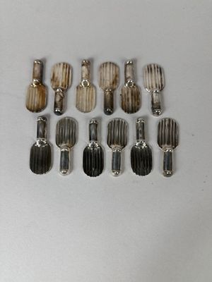 a lot of silver spoons and spoons on a table