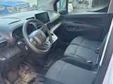 the interior of a car with the door open and the driver ' s seat down