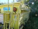 a yellow dump truck that is parked in the grass