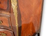 a small chest of drawers with a marble top