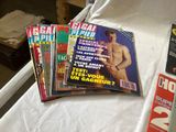 a lot of magazines sitting on a bed next to each other