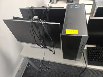 Plusieurs ordinateurs sont posés sur un bureau, accompagnés d'un clavier et d'une souris.