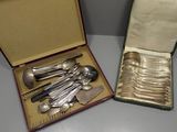 a lot of silver spoons and spoons in a box