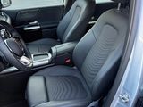 the interior of a car with the door open and the passenger seat up