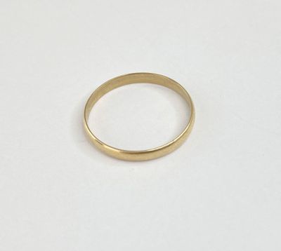 a gold ring on a white surface