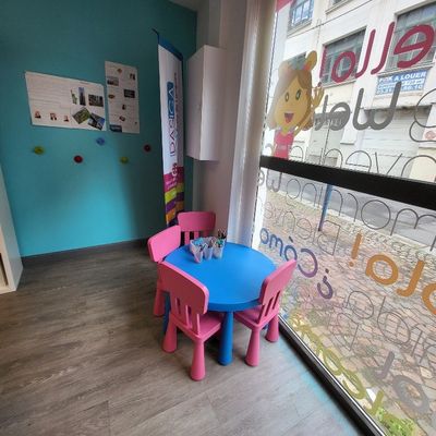 brightly colored children ' s table and chairs in front of a window