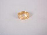a close up of a gold ring on a white surface