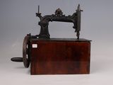 an antique sewing machine sitting on top of a wooden table