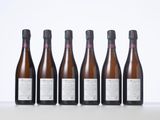 six bottles of wine lined up in a row on a table