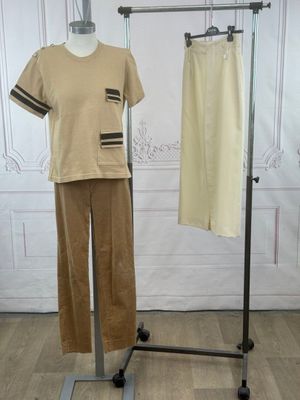 a mannequin and pants on a stand in a room