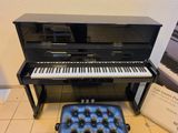 a piano that is sitting next to a chair