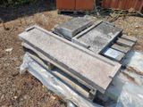 a pile of concrete blocks on the ground in the yard