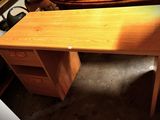 a wooden desk with a drawer underneath it in a room