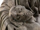 a statue of a man laying on a woman ' s chest