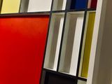 brightly colored bookshelves are lined up against a white wall