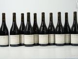six bottles of wine are lined up in a row on a table