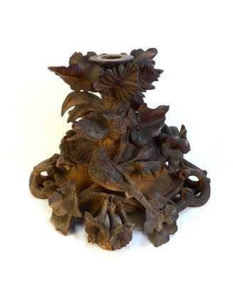 a wooden sculpture of a dragon with flowers on it