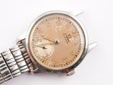 a close up of a wrist watch on a white surface