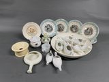 many different types of plates and bowls on the table