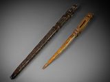 two carved wooden pens sitting next to each other on top of a table