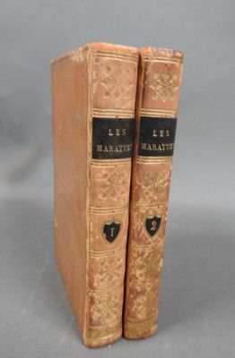 pair of antique leather books with black bindings on each of them