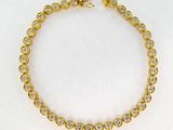 un bracelet en or jaune serti de diamants sur fond blanc