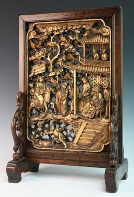 carved wooden panel with a scene of a boat and people