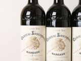 three bottles of wine sitting on top of a wooden table