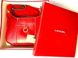 a red box with a red purse inside of it