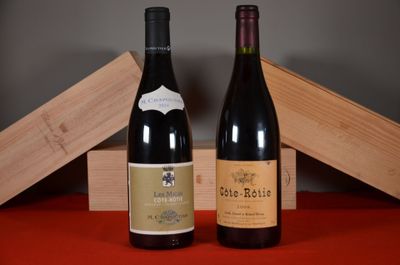 two bottles of wine sitting next to each other on a table
