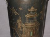 a black and gold bucket with a pagoda design on it