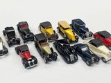several toy cars are lined up in a row on a white surface