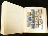 an open book with stamps on it sitting on a table