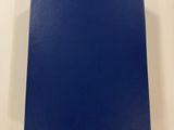 a blue book sitting on top of a white table