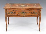 an old wooden table with a floral design on the top