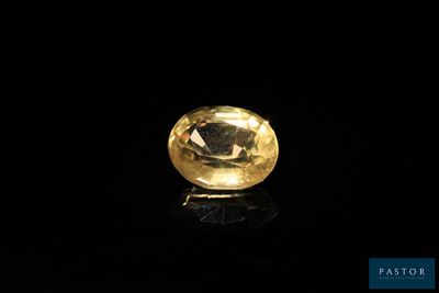 a yellow diamond on a black surface