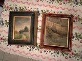 two paintings on the wall next to each other on the table