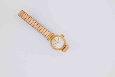 a close up of a wrist watch on a white surface