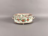 an image of a white bowl with red and green flowers on it