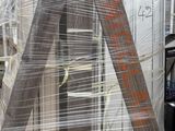 a ladder that has been wrapped in plastic and sitting on a pallet