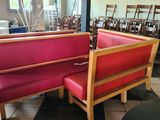 two red booths in a restaurant with a black table