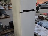 a refrigerator that is sitting on a pallet in a warehouse