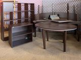 a room with a desk, bookshelf, and other furniture in it
